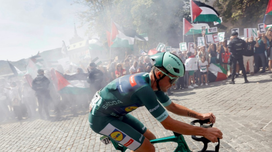 Cyclists swerve protest group in road during Vuelta stage 20