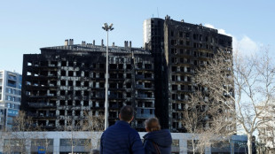 Valencia falls silent to recall housing block inferno victims